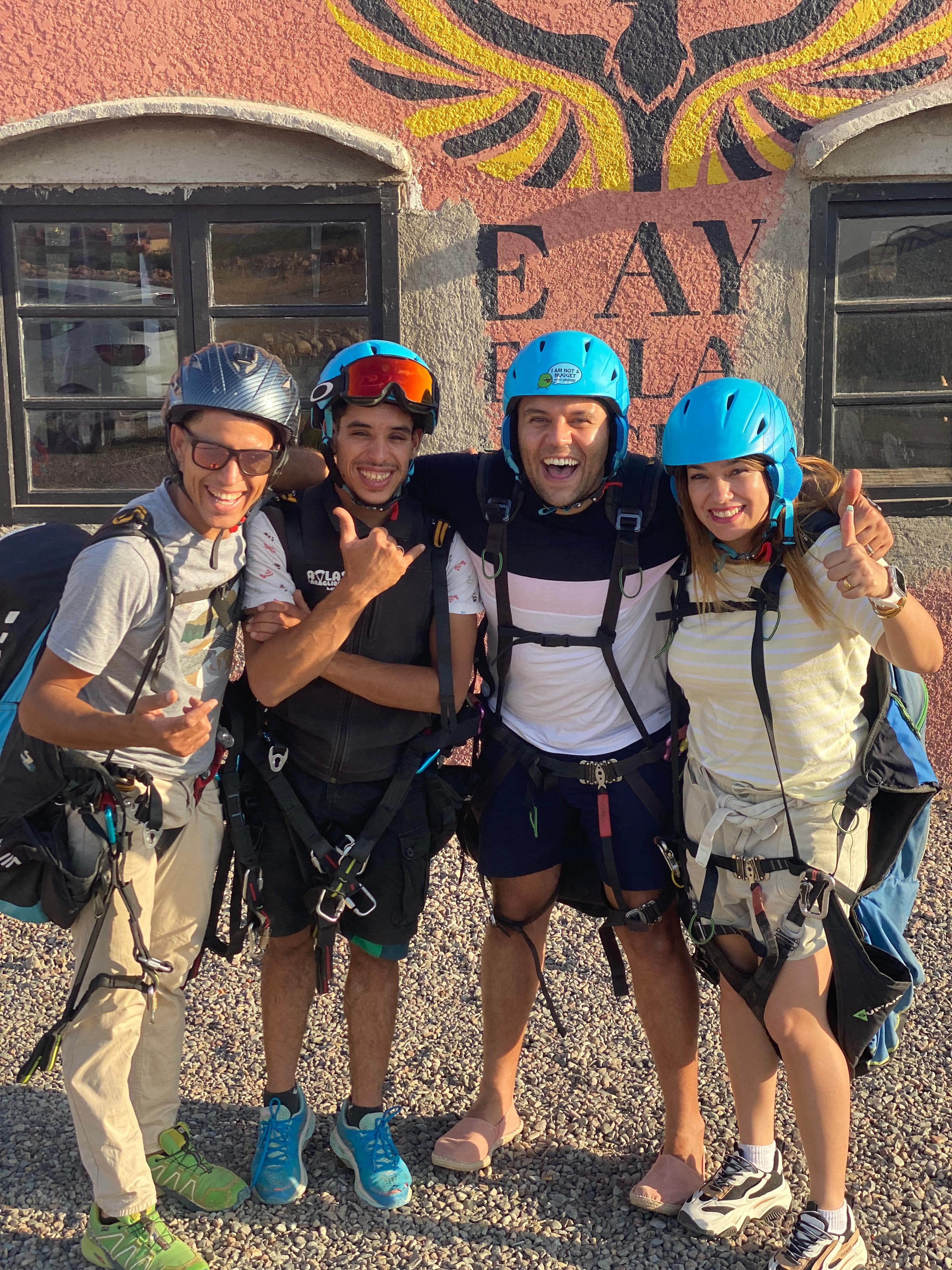 A local Moroccan mountain guide and travelers in the High Atlas landscape.